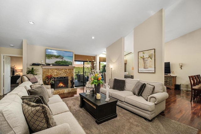 living room with vaulted ceiling and hardwood / wood-style flooring