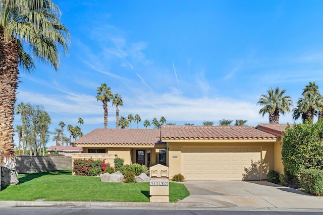 view of front of property with a front lawn and a garage