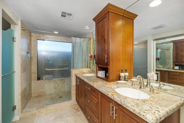 bathroom featuring vanity and an enclosed shower