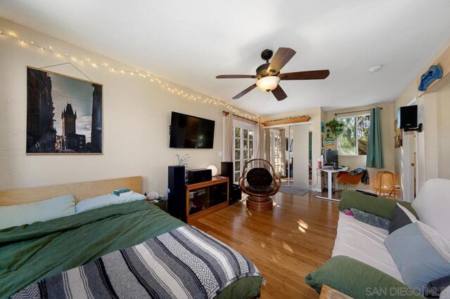 bedroom with ceiling fan and wood-type flooring