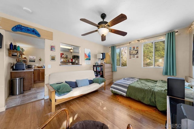 bedroom with light wood-type flooring and ceiling fan