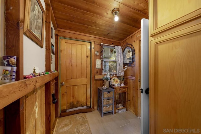 corridor featuring wood ceiling and wooden walls