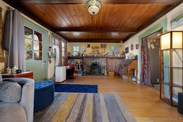 interior space with light hardwood / wood-style floors, wooden ceiling, beam ceiling, and a fireplace