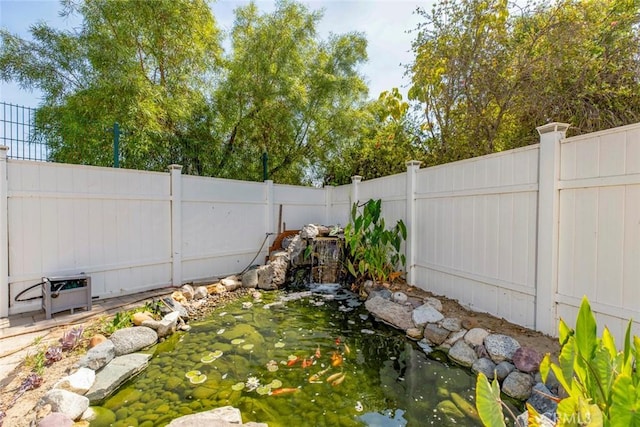 view of yard featuring a garden pond