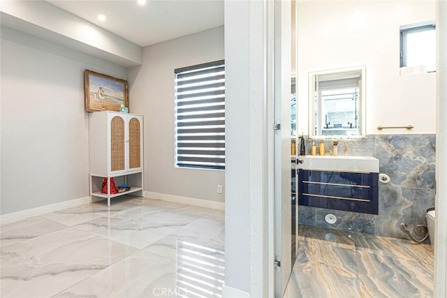 bathroom with plenty of natural light, toilet, and vanity