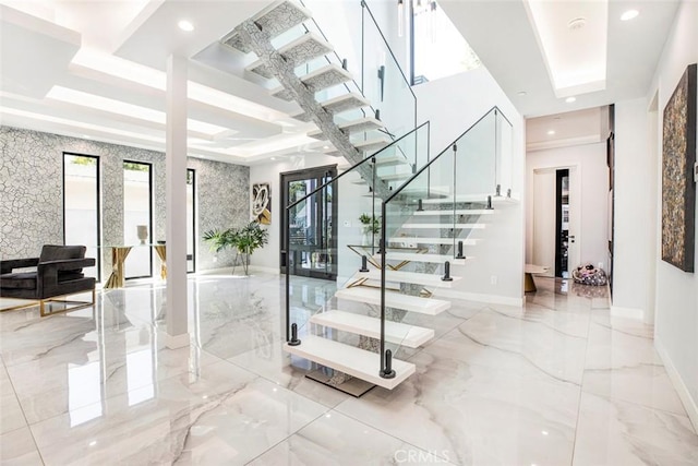 staircase featuring a tray ceiling