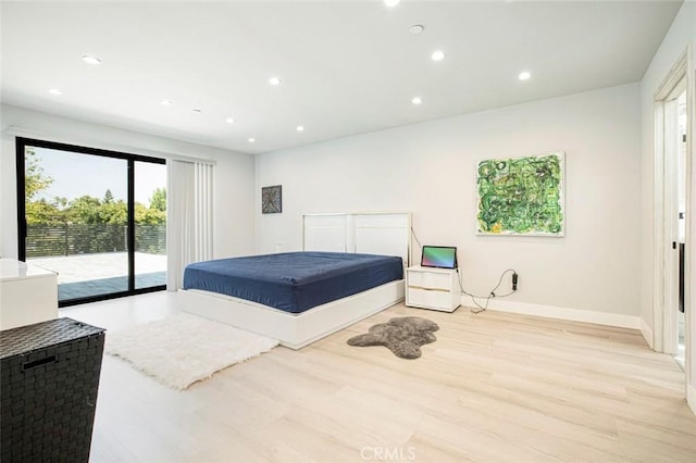 bedroom with access to exterior and light hardwood / wood-style floors