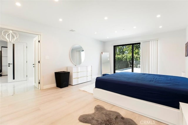 bedroom featuring light hardwood / wood-style floors, access to exterior, and white fridge