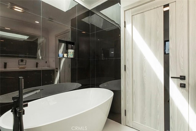 bathroom featuring tile walls, vanity, and separate shower and tub