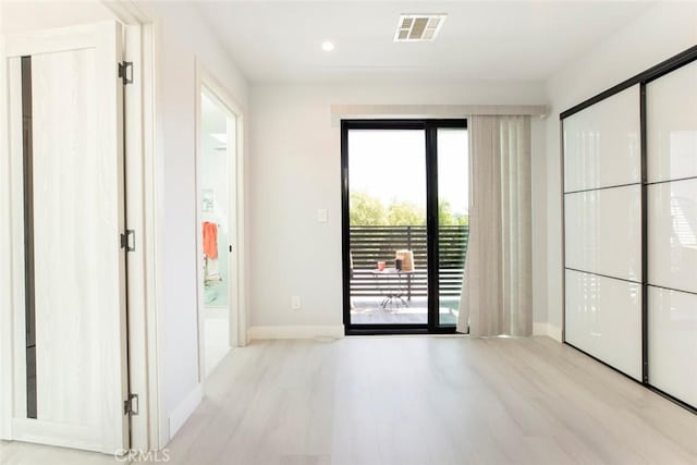 spare room featuring light hardwood / wood-style floors