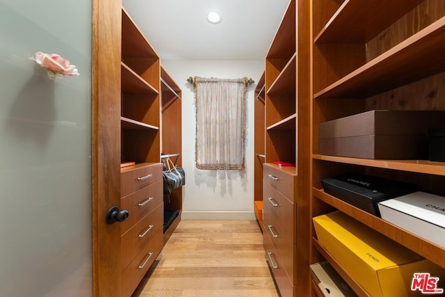 spacious closet featuring light hardwood / wood-style floors