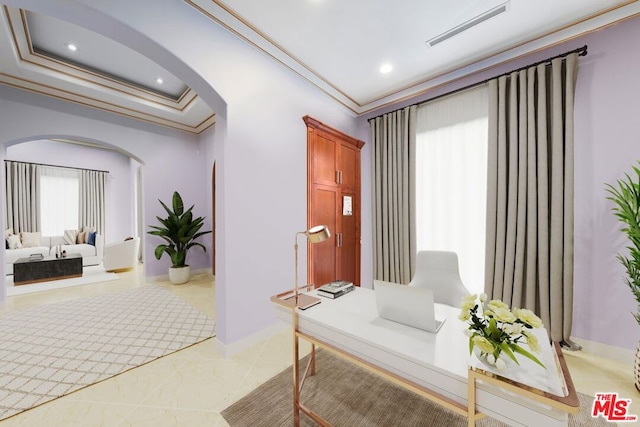 hall with light tile patterned floors, a tray ceiling, and crown molding