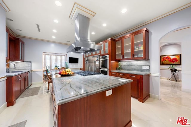 kitchen featuring island range hood, a center island, crown molding, light stone counters, and sink