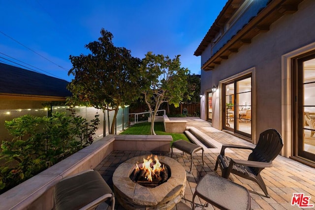 patio terrace at dusk with a fire pit