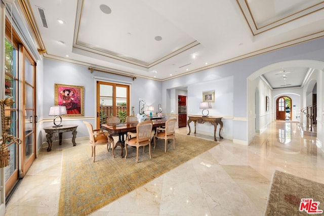 dining room with a raised ceiling, french doors, and crown molding