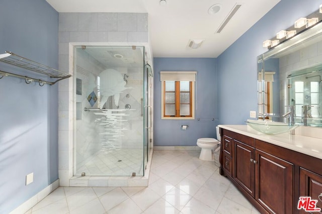 bathroom with a shower with door, plenty of natural light, and vanity