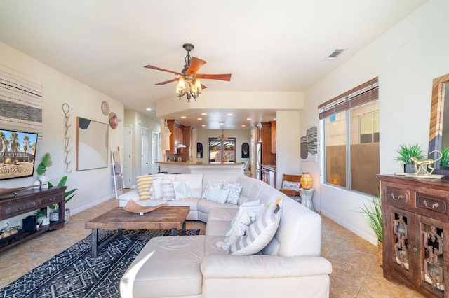 living room featuring ceiling fan and light tile patterned flooring