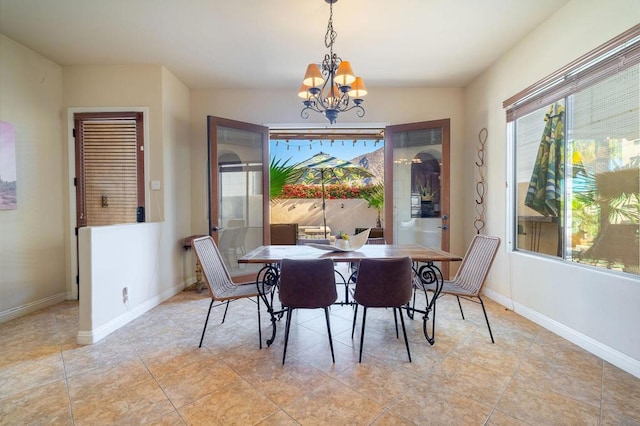 dining area with an inviting chandelier and light tile patterned floors