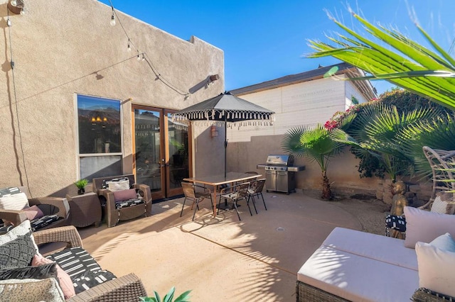 view of patio / terrace with outdoor lounge area, french doors, and grilling area