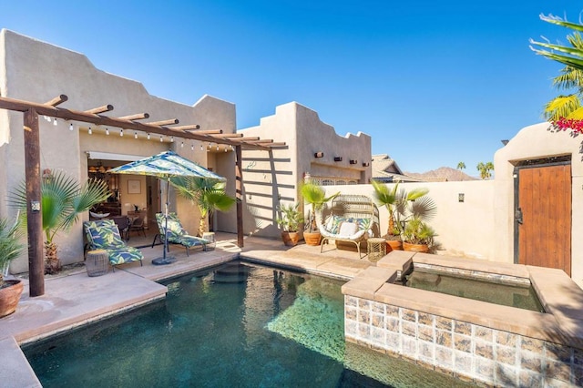 view of pool with an in ground hot tub and a patio