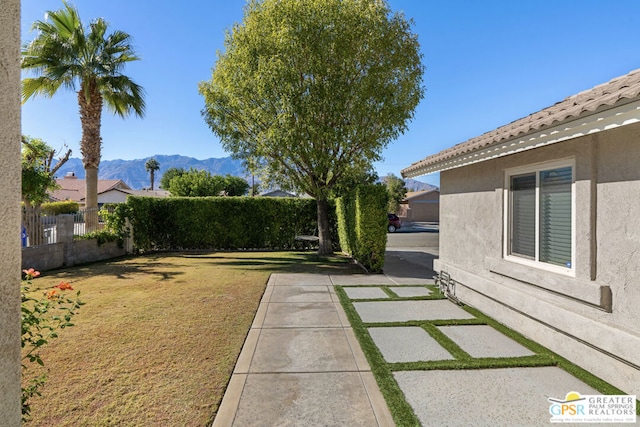 view of yard with a mountain view and a patio