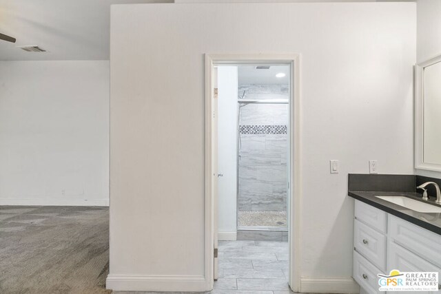 bathroom with walk in shower and vanity