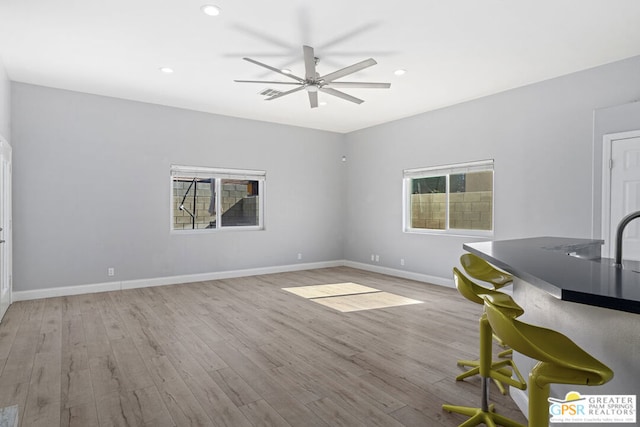 interior space featuring ceiling fan, a healthy amount of sunlight, and light wood-type flooring