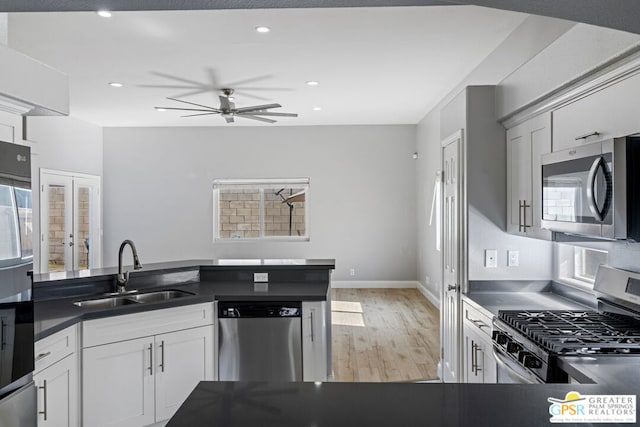 kitchen with a wealth of natural light, french doors, appliances with stainless steel finishes, and sink