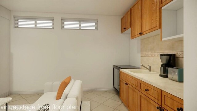 bathroom featuring sink, backsplash, tile patterned floors, and a wealth of natural light