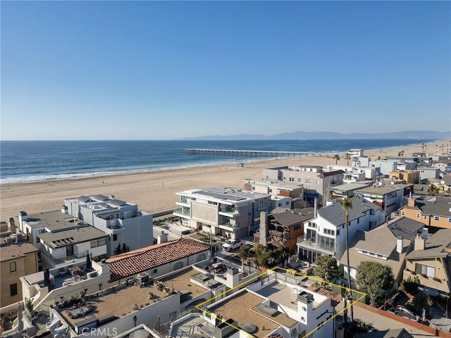 bird's eye view featuring a water view and a beach view