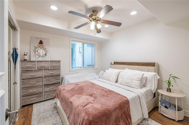 bedroom with ceiling fan and hardwood / wood-style flooring