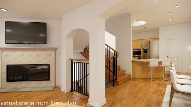 living room featuring light hardwood / wood-style floors and a fireplace