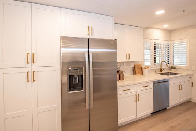 kitchen with white cabinetry, sink, and appliances with stainless steel finishes