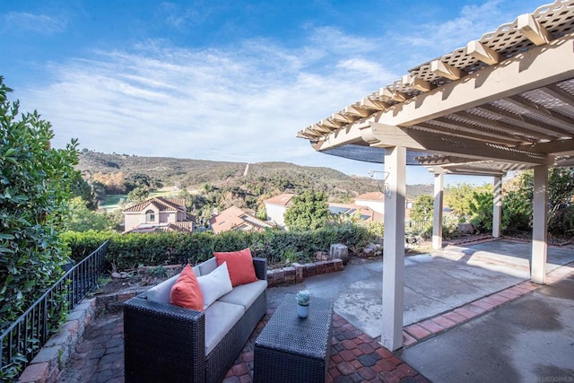 view of patio / terrace with a mountain view, a pergola, and an outdoor hangout area