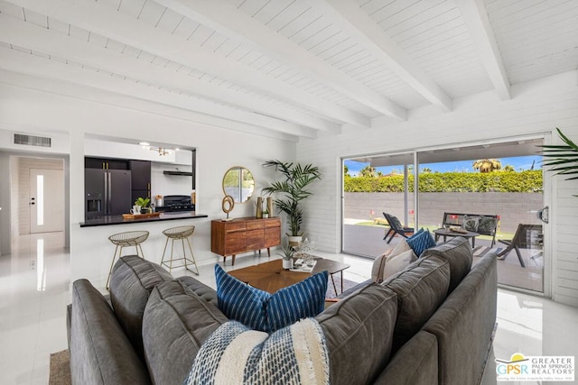 living room featuring tile patterned floors, wooden ceiling, and beamed ceiling