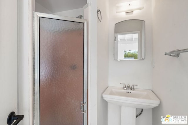 bathroom featuring sink, a wall mounted air conditioner, and a shower with shower door