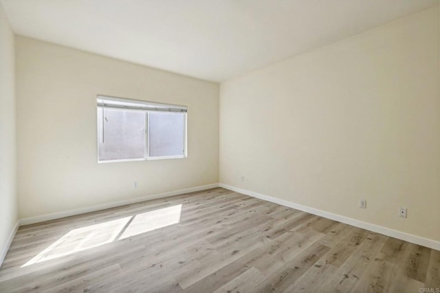 spare room with light wood-type flooring