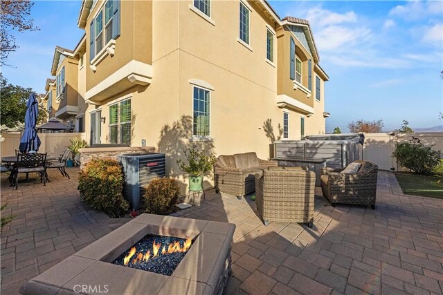 view of patio featuring an outdoor living space with a fire pit