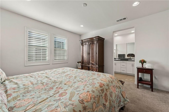 carpeted bedroom with ensuite bath