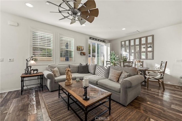 living room featuring ceiling fan and dark hardwood / wood-style flooring