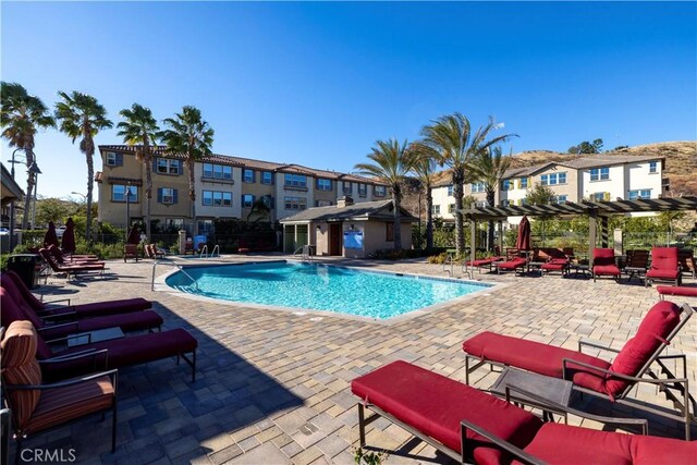 view of pool with a pergola and a patio area