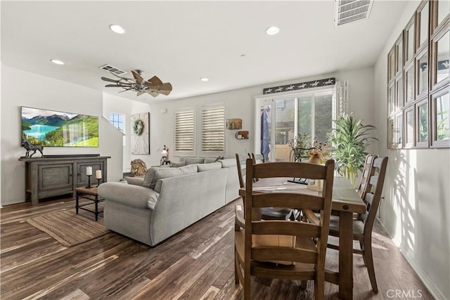 living room with dark wood-type flooring and ceiling fan