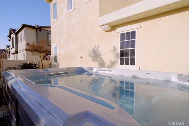 view of pool with a hot tub