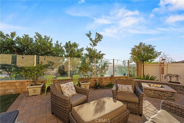 view of patio / terrace featuring an outdoor living space with a fire pit