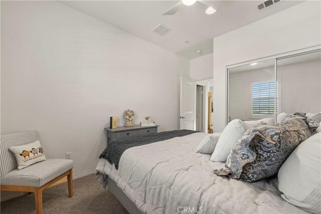 carpeted bedroom featuring ceiling fan and a closet