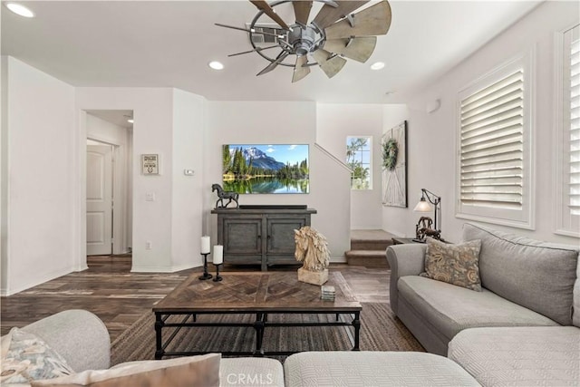 living room with ceiling fan and dark wood-type flooring