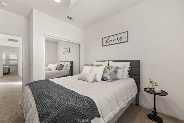 bedroom with a closet, carpet flooring, and ceiling fan