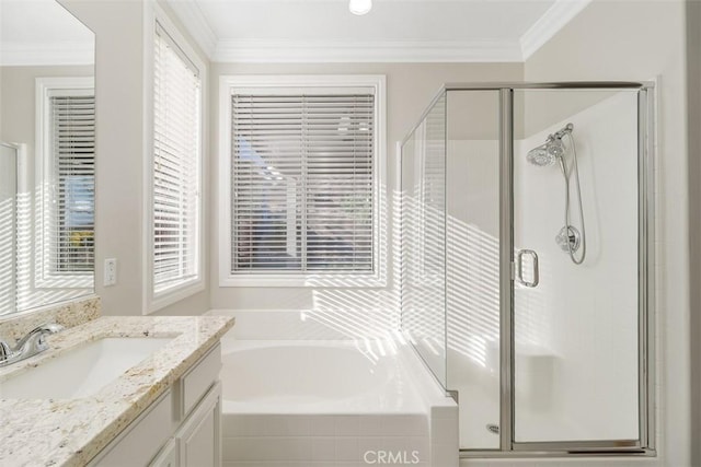 bathroom featuring vanity, plenty of natural light, ornamental molding, and shower with separate bathtub