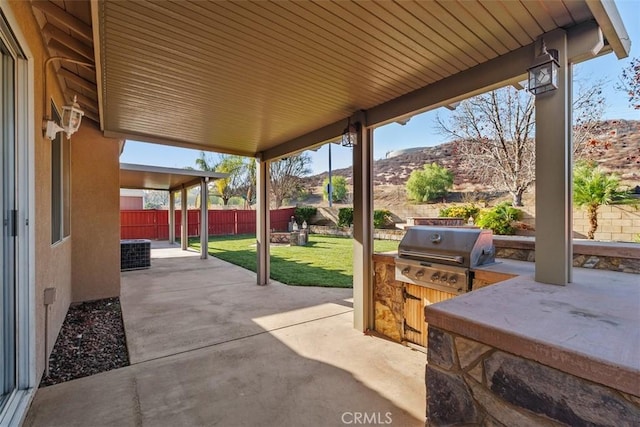 view of patio featuring an outdoor kitchen, a mountain view, area for grilling, and central air condition unit