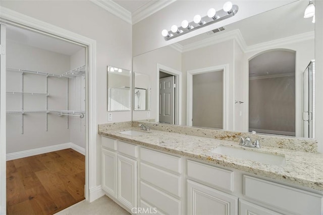 bathroom with vanity, wood-type flooring, and crown molding